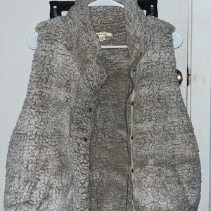 Fuzzy vest with zipper and buttons. Very cute and cozy!